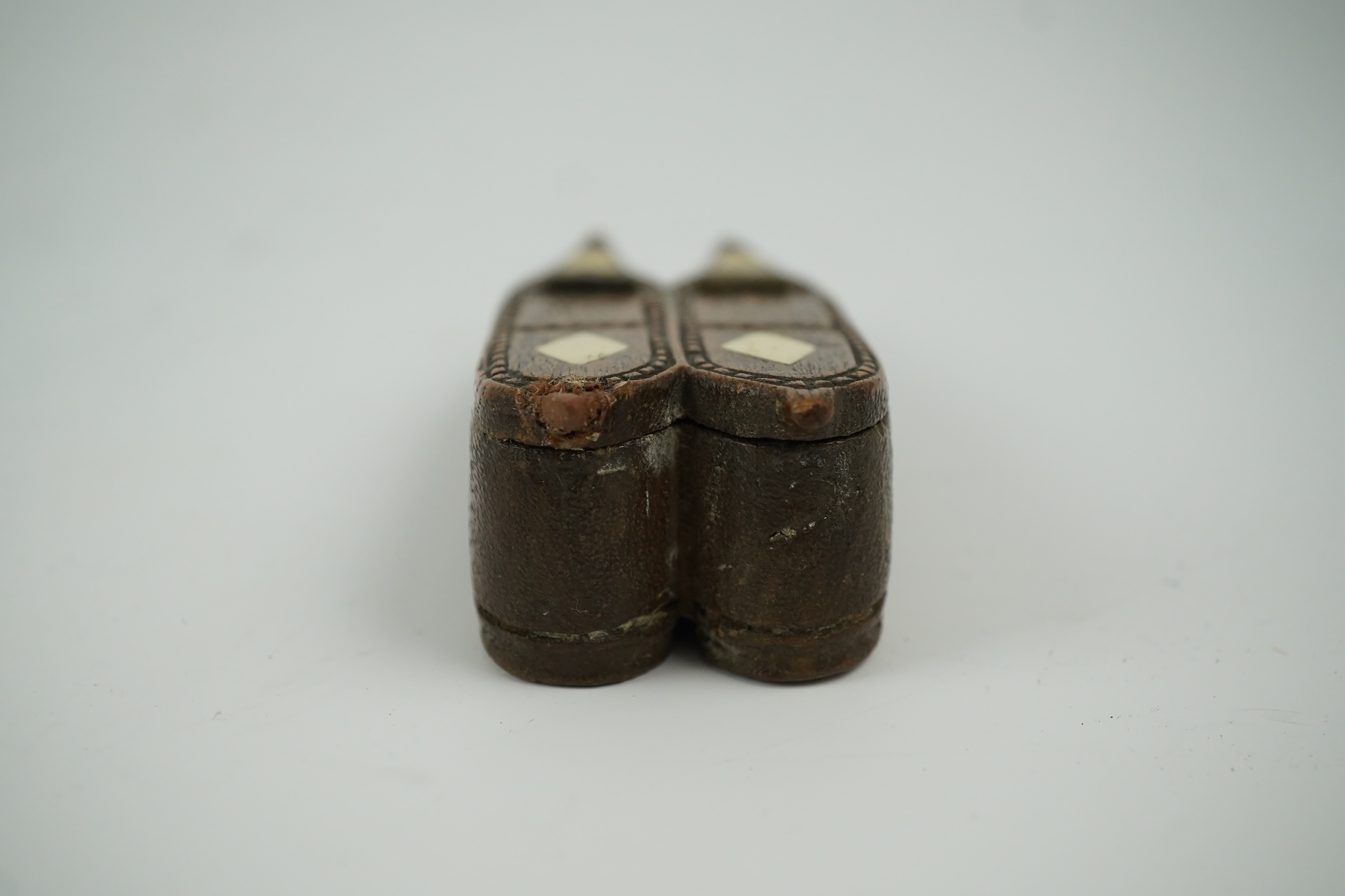 An early 19th century bone inset carved wood 'pair of shoes' snuff box with damaged sprung lid, 9.5cm long. Condition - good